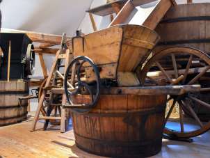 In einem Raum stehen diverse Geräte aus Holz, die früher im Weinbau verwendet wurden.