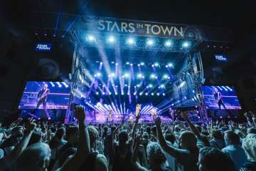 Stars in Town Schaffhausen Konzert mit einer grossen Bühne und viel Publikum sowie Schweinwerfer mit blauem Licht.